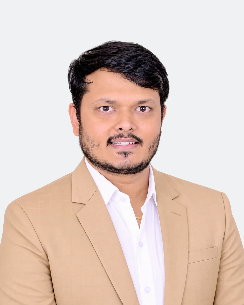 CA Devendra Kumar Jain, founder of Saramis Global, in a tan jacket.